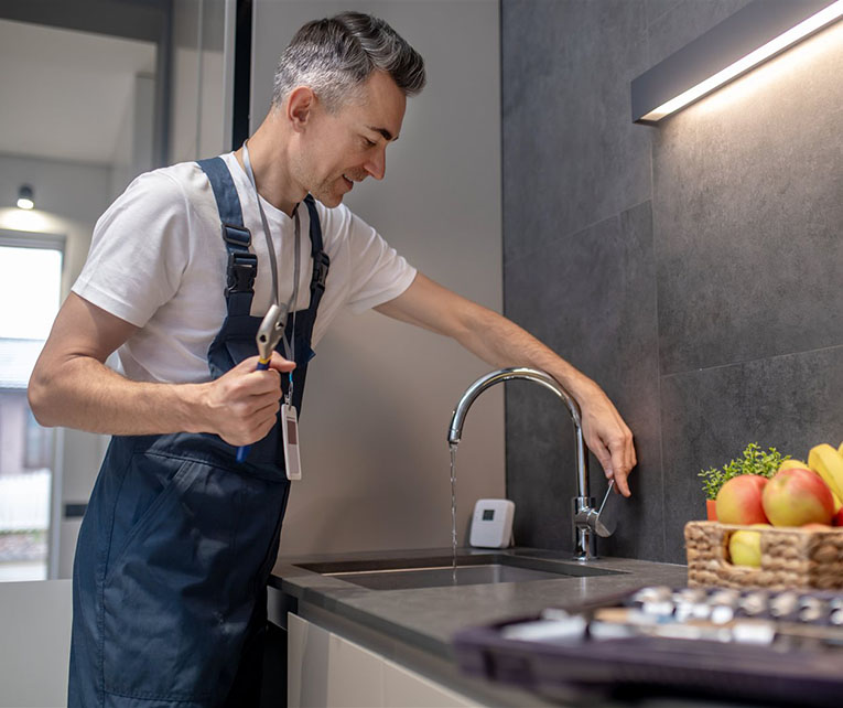 Faucet specialist installing a kitchen faucet
